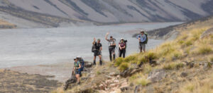 Hikers hight on a hillside with a braided river in the background - banner image
