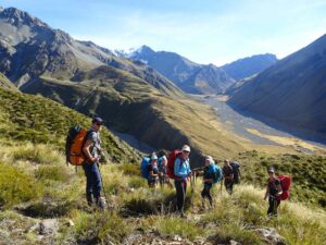 Hikers resting high above a valley on a Mackenzie Alpine Hiking Tour