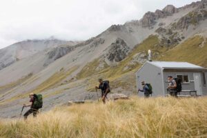 Hikers leaving Falcons Nest Hut in the Mackenzie Country