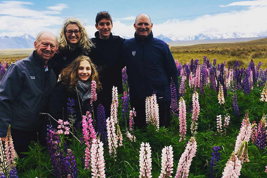 5 people standing among lupins on a lake tekapo farm tour