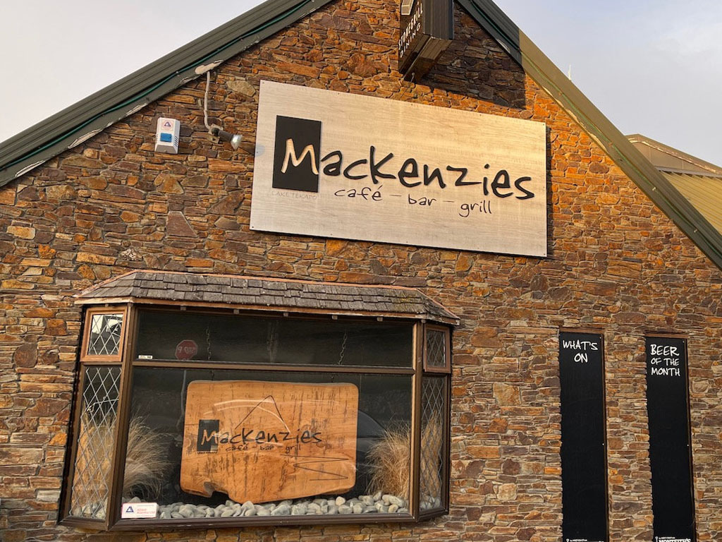 front of vuilding with large sign showing Mackenzies cafe, bar, grill